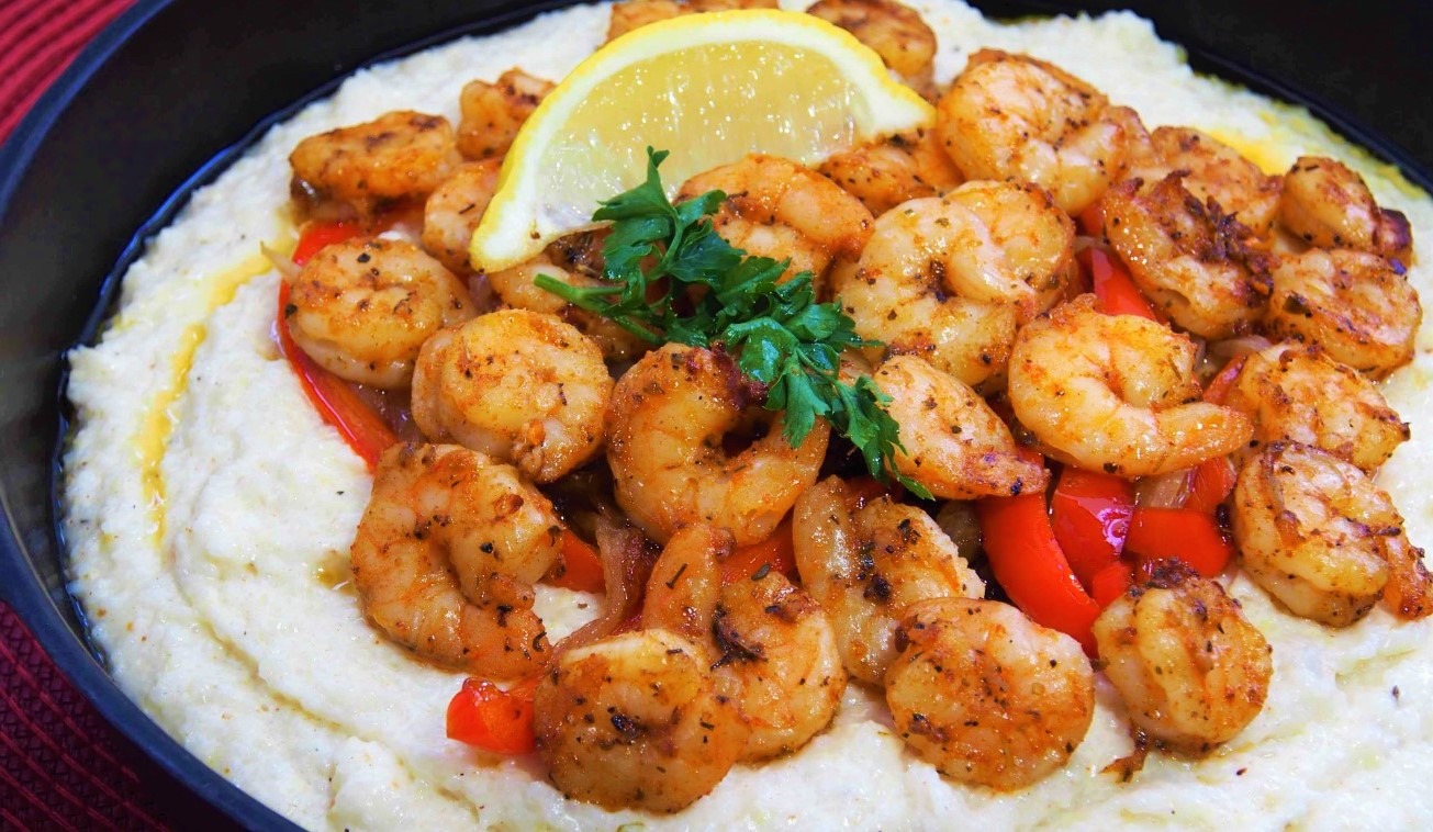 A close-up image of a plate of Cajun Shrimp Scampi, with large succulent shrimp and a spicy Cajun sauce. Cajun Shrimp Scampi is a delicious and spicy dish made with large shrimp, garlic, onions, and bell peppers. Perfect for a quick and easy weeknight meal or special occasion.