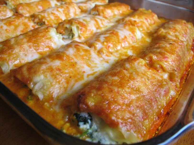 Close-up of homemade lasagna rolls filled with meat and cheese, baked with marinara sauce and topped with melted mozzarella cheese.