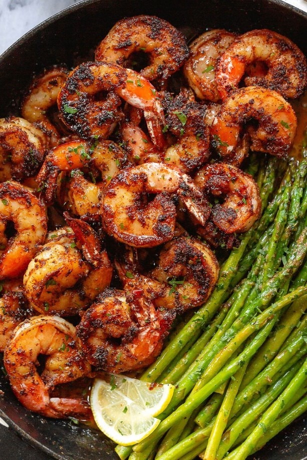A delicious and healthy meal of lemon garlic butter shrimp with asparagus on a plate.