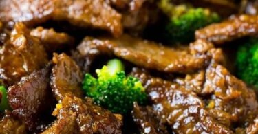 A plate of flavorful Beef and Broccoli stir fry with tender beef slices and vibrant green broccoli florets
