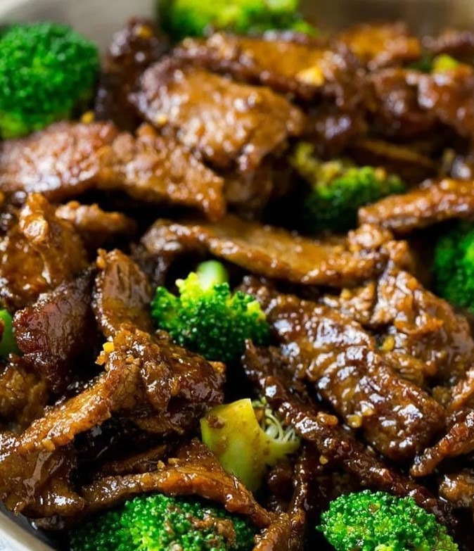 A plate of flavorful Beef and Broccoli stir fry with tender beef slices and vibrant green broccoli florets