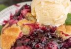 Journey into the heart of summer with this luscious blackberry cobbler. With every bite, you'll be greeted by the sweet tartness of ripe blackberries, beautifully complemented by a crispy, golden brown butter topping. This dessert is nostalgia and warmth served in one dish.