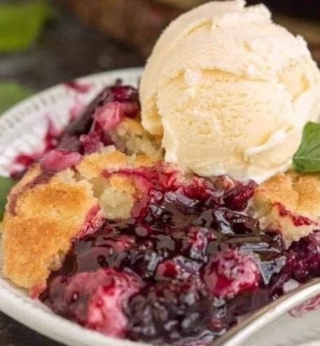 Journey into the heart of summer with this luscious blackberry cobbler. With every bite, you'll be greeted by the sweet tartness of ripe blackberries, beautifully complemented by a crispy, golden brown butter topping. This dessert is nostalgia and warmth served in one dish.