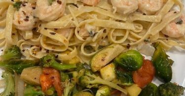 Shrimp scampi over fettuccine Alfredo glazed brussels sprouts and mixed vegetables