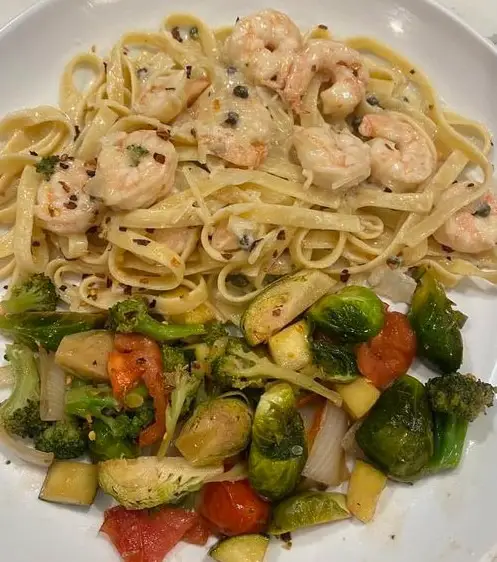 Shrimp scampi over fettuccine Alfredo glazed brussels sprouts and mixed vegetables