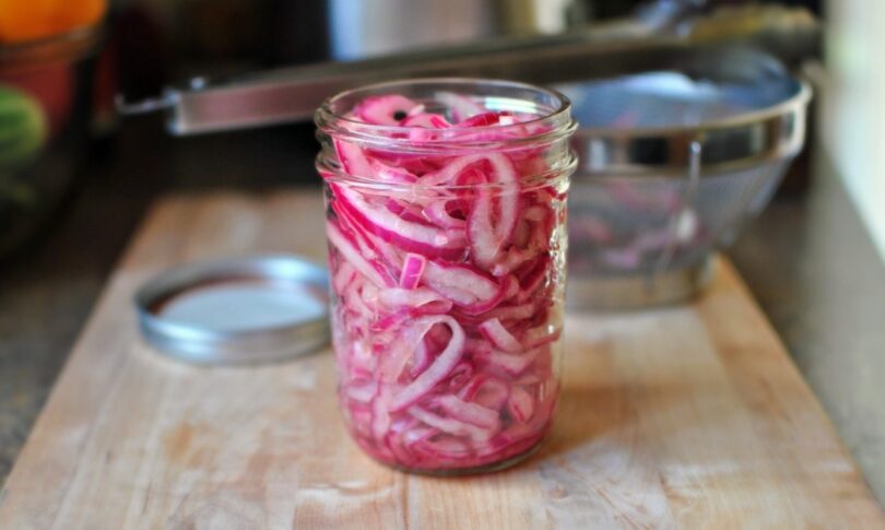 Pickled red onions in a jar